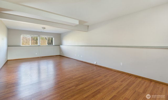 spare room with wood finished floors and baseboards