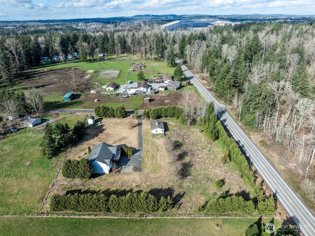 birds eye view of property with a forest view