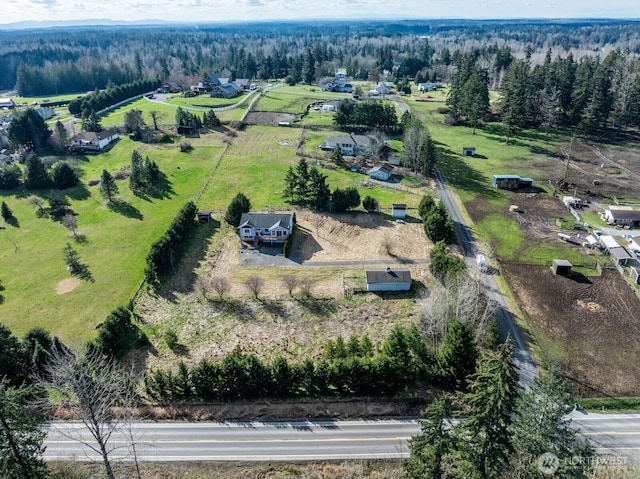 birds eye view of property featuring a rural view and a forest view