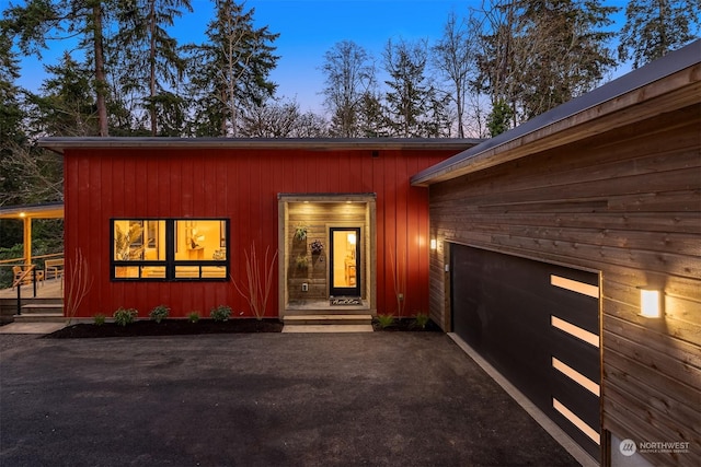 exterior entry at dusk with a garage