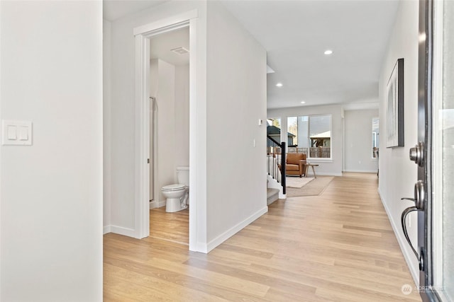 hall with light hardwood / wood-style flooring