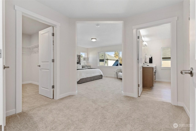 bedroom with light colored carpet and sink