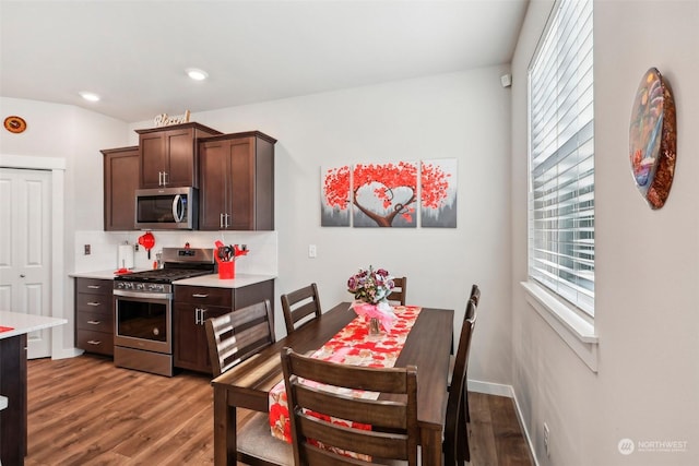 kitchen with hardwood / wood-style floors, dark brown cabinets, and stainless steel appliances