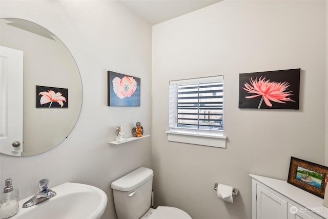 bathroom with toilet and sink