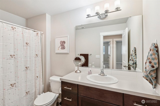 bathroom featuring vanity and toilet