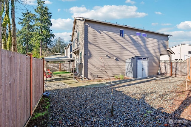 back of property featuring a gazebo and a patio area