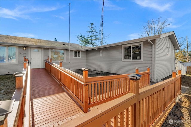 back of house featuring a wooden deck