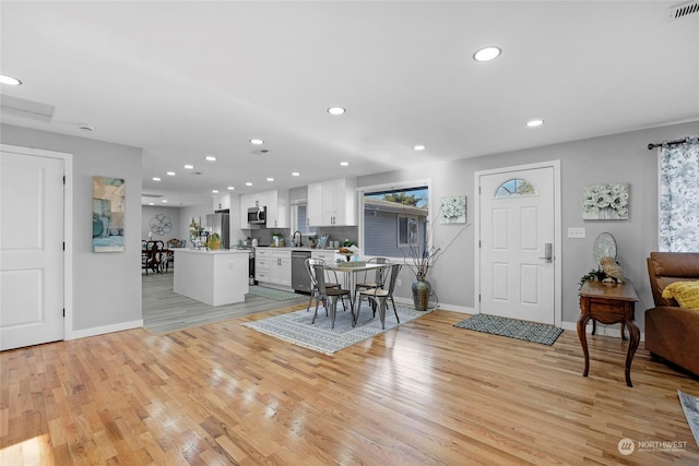 dining area featuring sink and light hardwood / wood-style floors