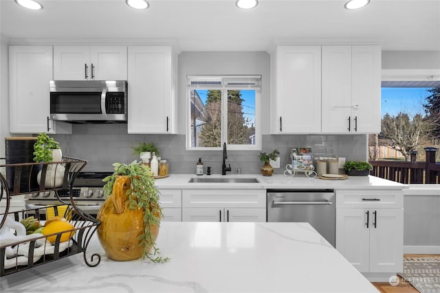 kitchen with white cabinetry, sink, and appliances with stainless steel finishes