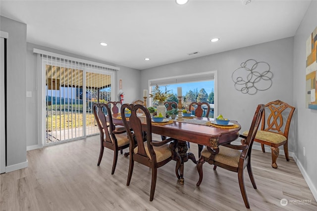 dining room featuring plenty of natural light and light hardwood / wood-style floors