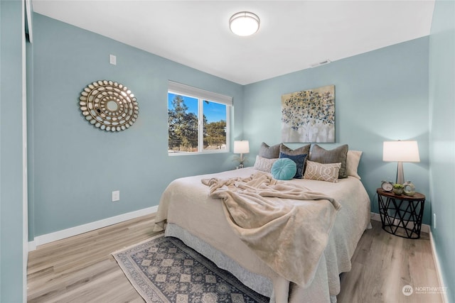 bedroom with light hardwood / wood-style flooring