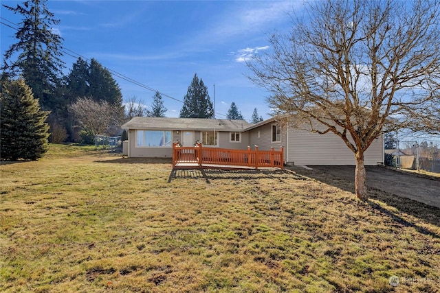 view of front facade featuring a front yard and a deck