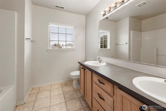 bathroom with visible vents, a sink, toilet, and double vanity