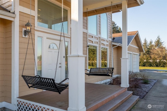 entrance to property with a garage and covered porch