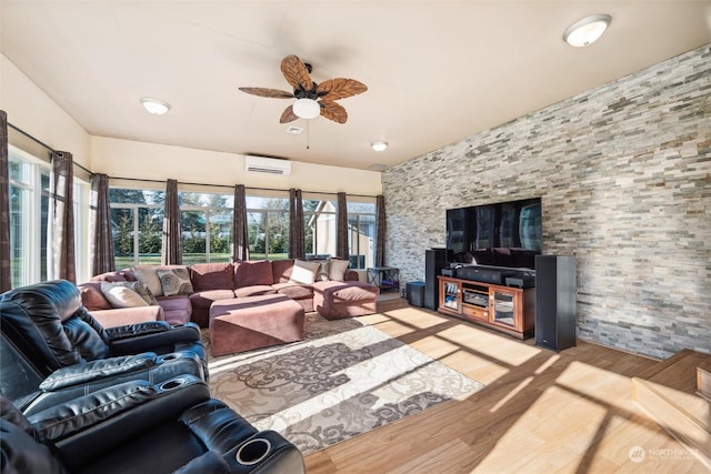 living room with ceiling fan, light wood-type flooring, and an AC wall unit