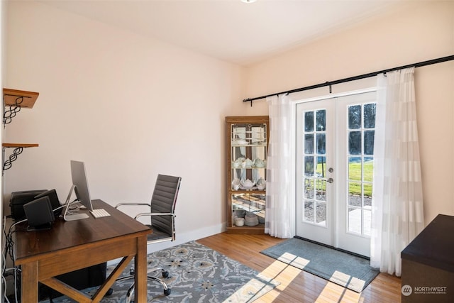 office featuring light hardwood / wood-style flooring and french doors