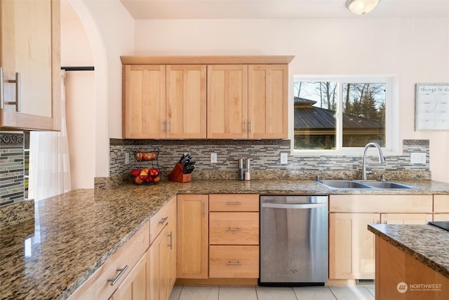 kitchen with sink, dishwasher, tasteful backsplash, stone countertops, and light brown cabinetry