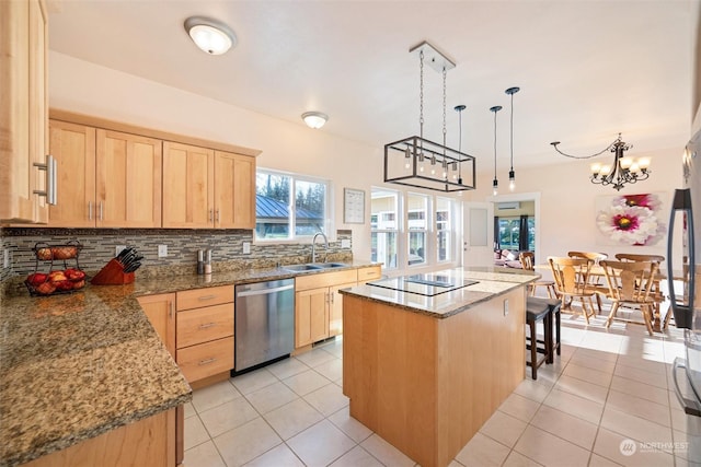 kitchen featuring light brown cabinetry, decorative light fixtures, sink, a center island, and stainless steel dishwasher