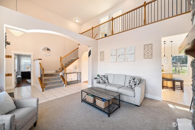 living room featuring light colored carpet and a high ceiling