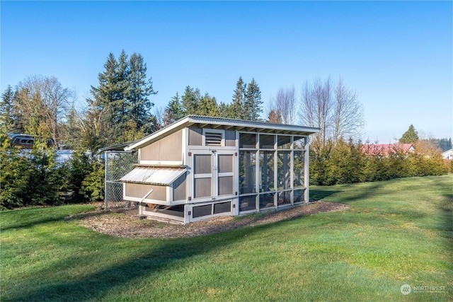 view of outbuilding with a yard