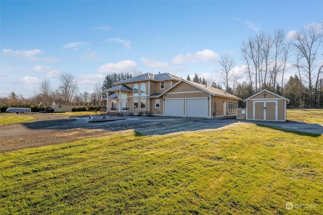 view of front of house featuring a garage, a front lawn, and a storage unit