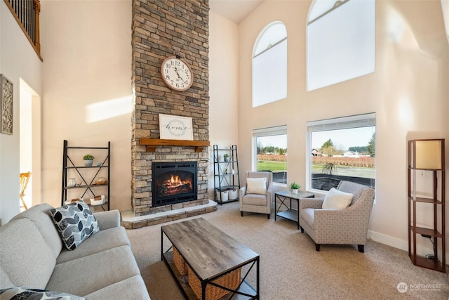 living room with a high ceiling, carpet floors, and a fireplace