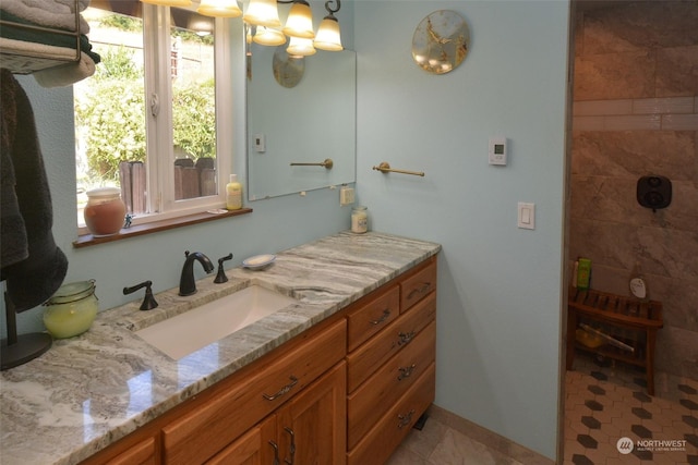 bathroom with vanity, tile patterned floors, and an inviting chandelier