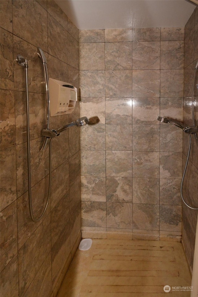 bathroom with a tile shower