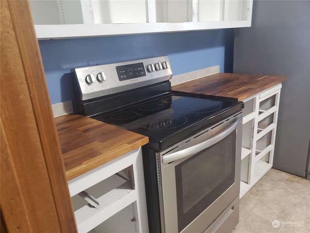 kitchen featuring butcher block counters and stainless steel electric range