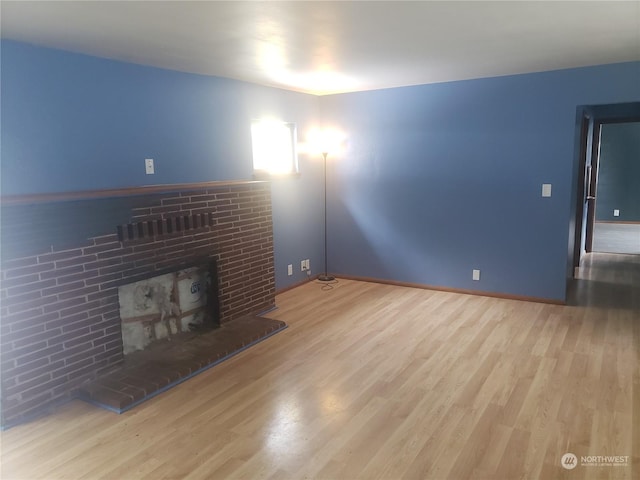 unfurnished living room with hardwood / wood-style floors and a fireplace