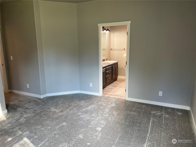 spare room featuring light colored carpet