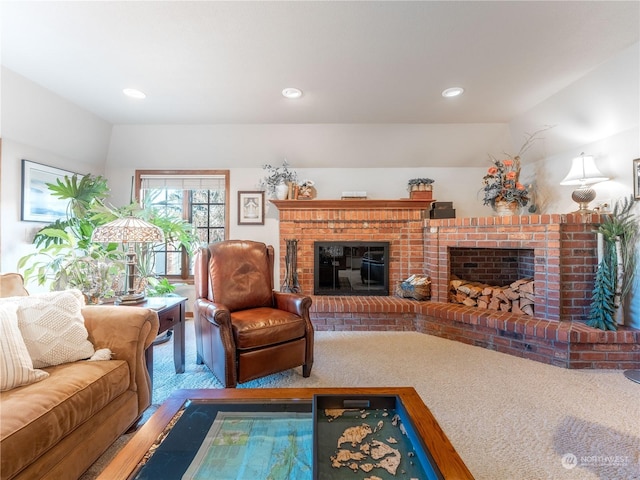 living room featuring a fireplace, vaulted ceiling, and carpet