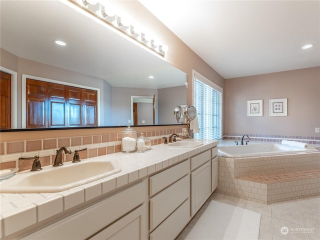 bathroom with vanity, tiled bath, and tile patterned floors