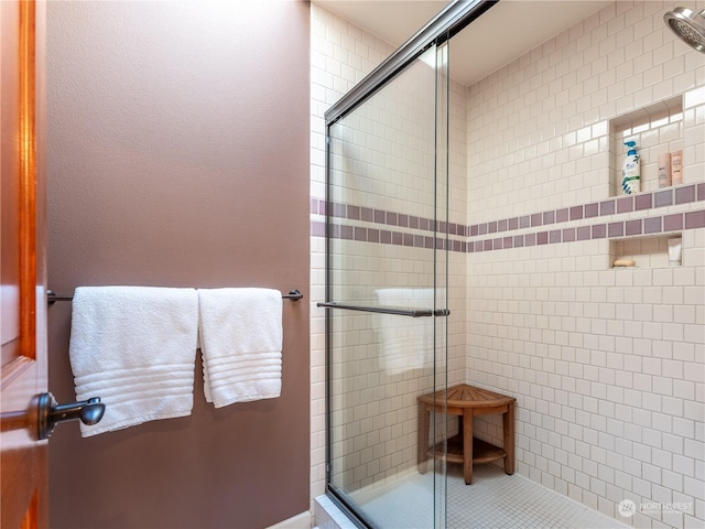 bathroom with a shower with door