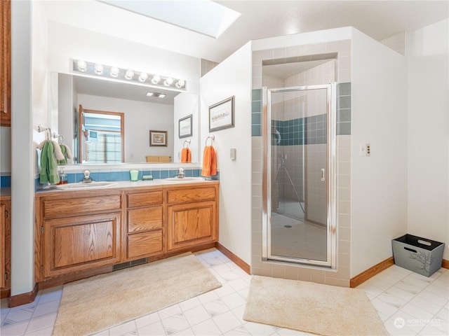 bathroom featuring walk in shower, vanity, and a skylight