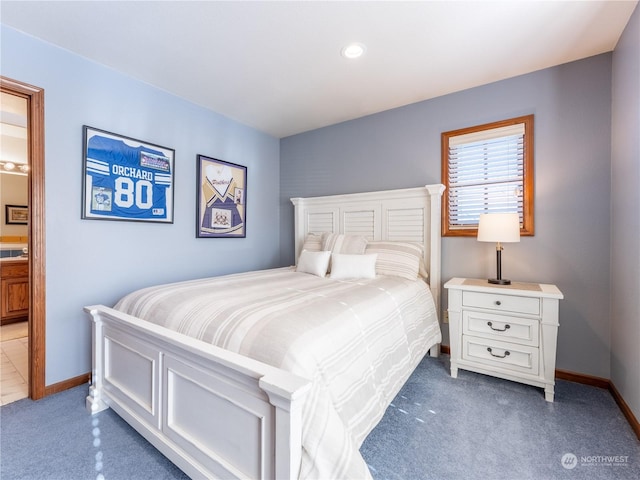 carpeted bedroom featuring ensuite bath