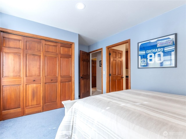 bedroom with light colored carpet and a closet