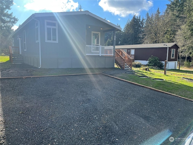 view of front of house with covered porch and a front yard