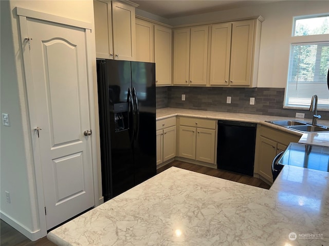 kitchen featuring sink, dark hardwood / wood-style floors, black appliances, decorative backsplash, and kitchen peninsula