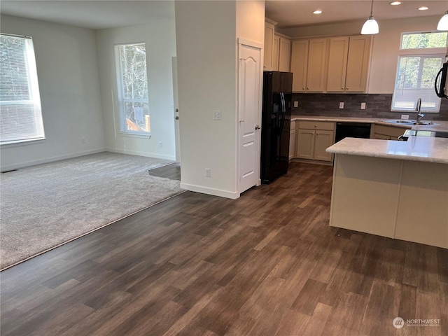 kitchen featuring sink, black appliances, hanging light fixtures, dark hardwood / wood-style flooring, and backsplash