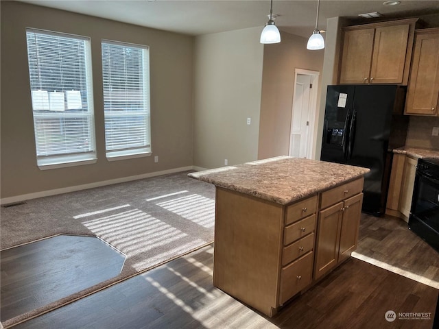 kitchen with pendant lighting, a center island, dark wood-type flooring, and black appliances