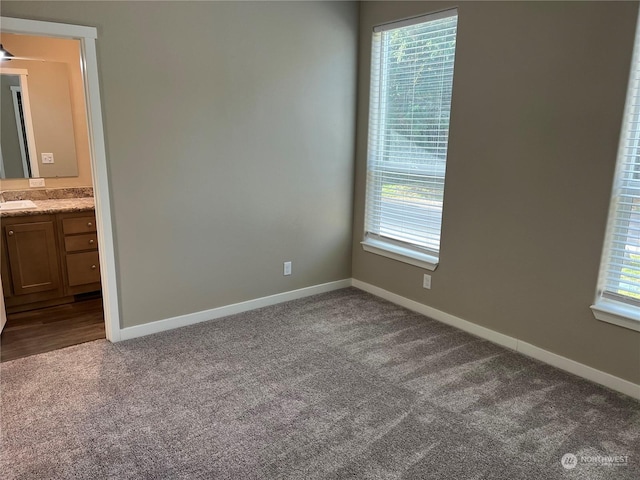 carpeted spare room featuring sink