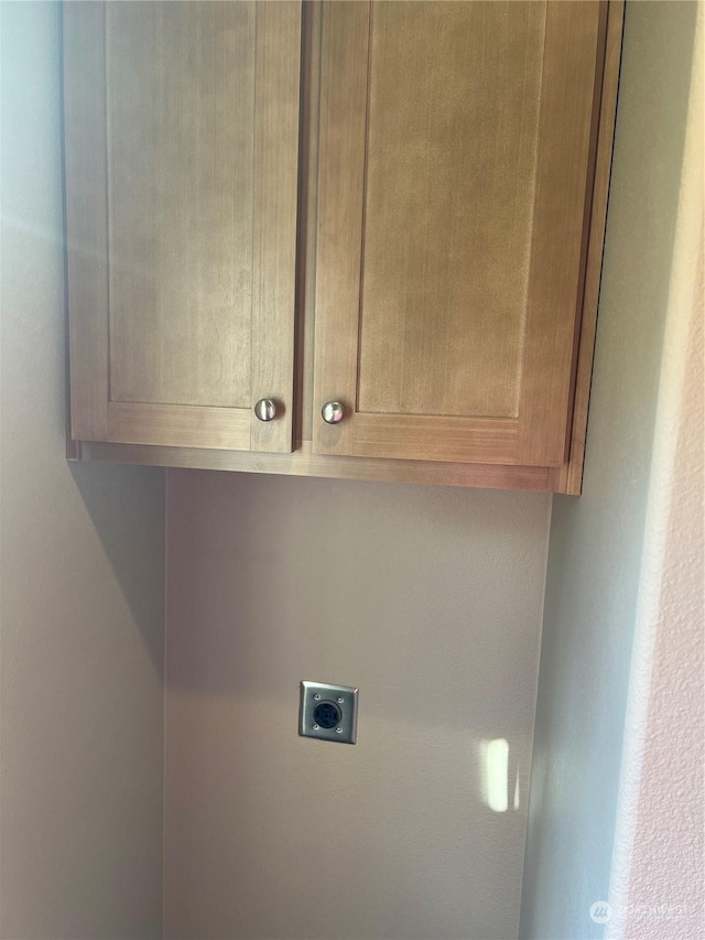 washroom featuring cabinets and electric dryer hookup