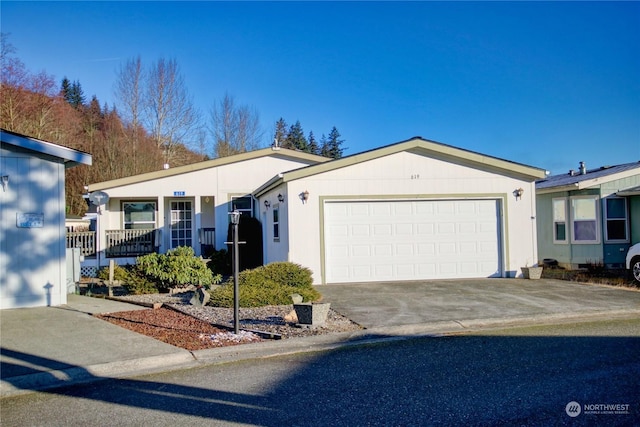 single story home with concrete driveway and an attached garage