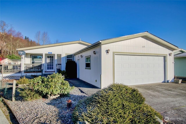 ranch-style home with covered porch, concrete driveway, and an attached garage