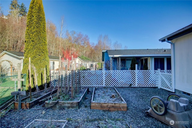 view of yard featuring a vegetable garden and fence