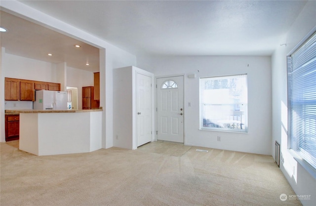 entrance foyer featuring recessed lighting, light carpet, and visible vents