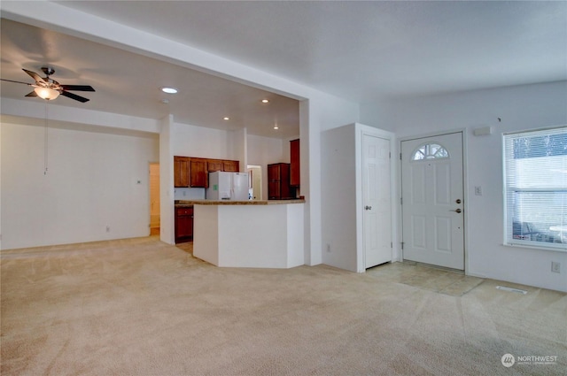 carpeted foyer with ceiling fan