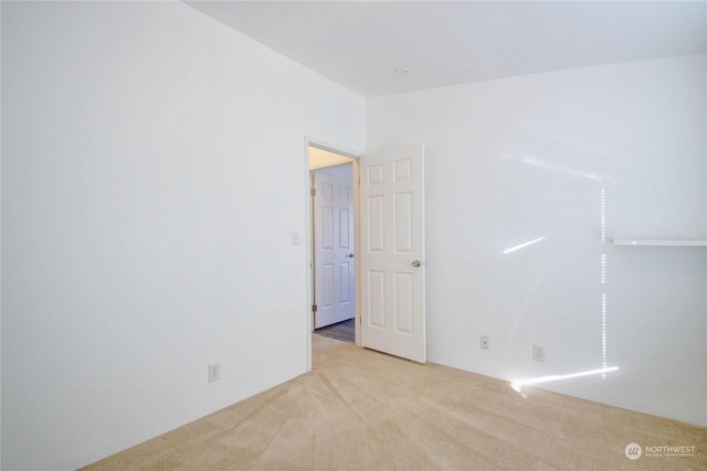 unfurnished room with light carpet