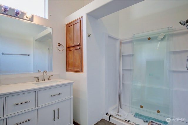 full bath featuring a shower stall and vanity